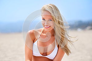 Sea, sun and summer fun. A gorgeous young blonde woman enjoying summer on the beach.