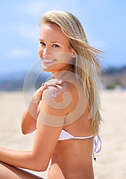 Sea, sun and summer fun. A gorgeous young blonde woman enjoying summer on the beach.