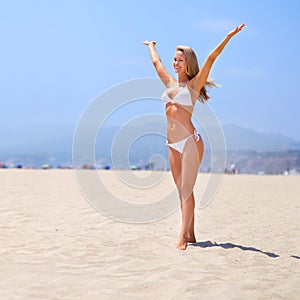 Sea, sun and summer fun. A gorgeous young blonde woman enjoying summer on the beach.