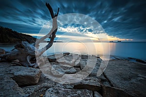 Sea sunrise at rocky beach