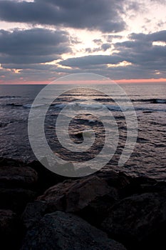 Sea before sunrise on a rocky beach