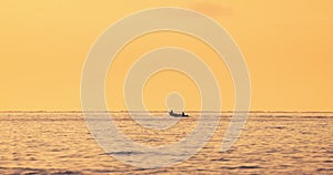 Sea sunrise and sailing fishing boat with fishermen over calm ripple water waves video