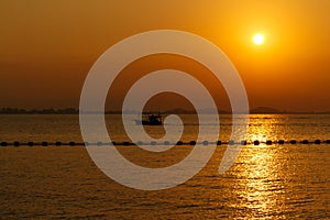 Sea sunset with boat silhouette