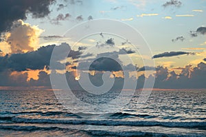 Sea sunset with cloudy sky and sun through the clouds over. Clouds Ocean and sky background, seascape.