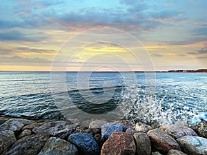 Sea sunset colorful evening sky and moon on cloudy  skyline,  light reflection on seawater, gold summer city  in   Tallinn old tow