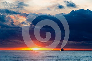 Sea sunset landscape with ship on the horizon