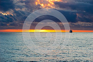 Sea sunset landscape with ship on the horizon