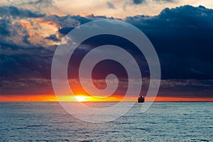 Sea sunset landscape with ship on the horizon