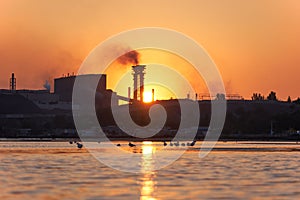 Sea sunset over the industrial zone of Azovstal plant