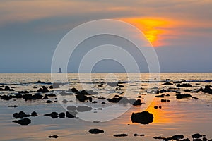 Sea at sunset rocky beach