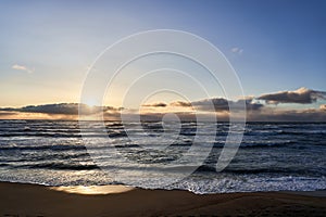 Sea sunset during strong surf and strong waves