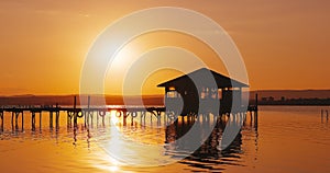 Sea sunset or sunrise and old wooden fishing jetty pier, calm nature landscape in 4K video. Travel destination.