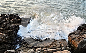 Sea surf splashing with rock