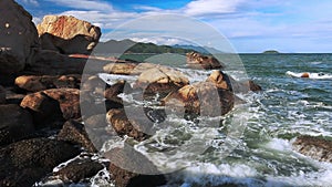 Sea surf. Waves breaking on the rocks and cliffs. Nha Trang, Vietnam.