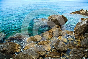 Sea surface, rocks on the beach close-up.