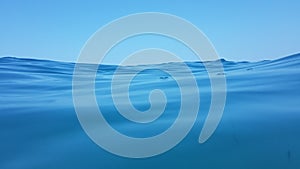 Sea surface waves diving blue sea