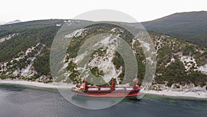 Sea tanker, dry cargo ship, washed ashore after a storm, aerial view