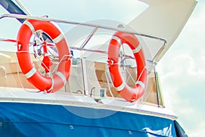 The sea theme. Two orange lifeboats aboard the yacht.