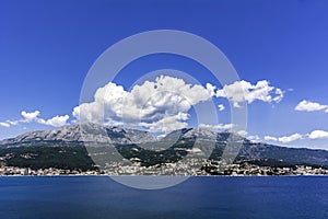 Sea town with mountains clouds and clear sky