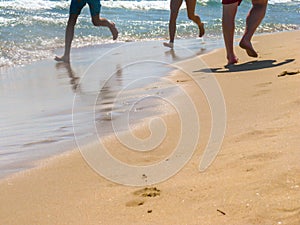 The sea transparent clear wave gradually washes away traces on the sand left by happy people