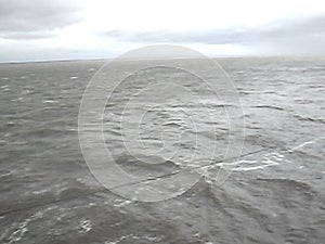 Sea of Troubles with the ship`s deck. Waves in cloudy weather