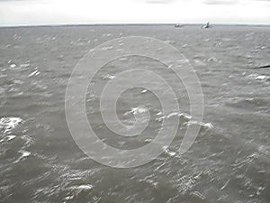 Sea of Troubles with the ship`s deck. Waves in cloudy weather