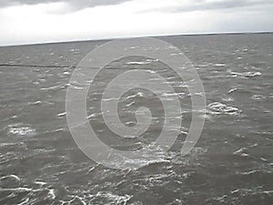 Sea of Troubles with the ship`s deck. Waves in cloudy weather