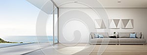 Sea view living room of luxury summer beach house with swimming pool and wooden terrace.