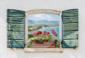 Sea view through the open window with flowers