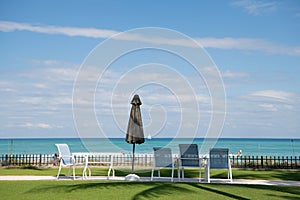 Sea view in Palm Beach Florida, USA. Beach umbrella and lounge chairs. Seaside holidays. Summer vacation