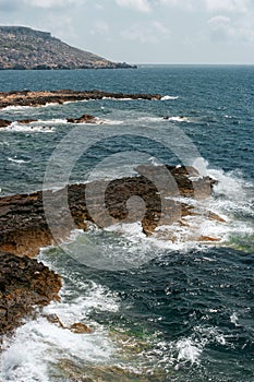 Sea view with rock and waves vertical