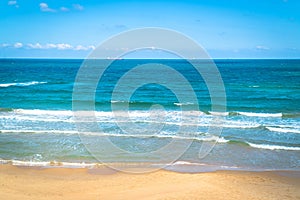 Sea view by the sandy beach against blue sky in Kilyos, cargoships at the far end, Black Sea Region in Istanbul