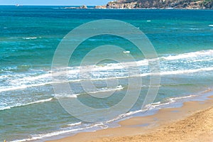 Sea view by the sandy beach against blueish sky in Kilyos, ship at the far end on the sea, Black Sea Region in Istanbul