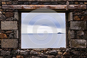 Sea view from a stone window of an old ruin near the ocean