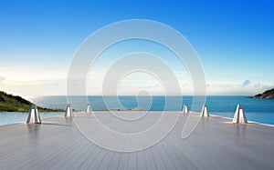 Sea view swimming pool and empty big terrace in modern luxury beach house with blue sky background, Lamps on large wooden deck photo