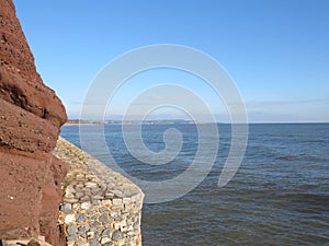 Sea Wall Dawlish looking out at sea in the sun