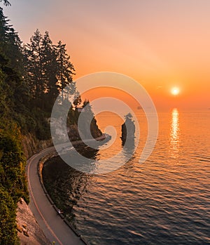 sea wall and Siwash Rock with red sunset sky backgrounds