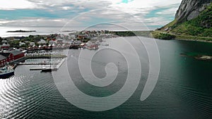 Sea water against small harbor town and mountain aerial view