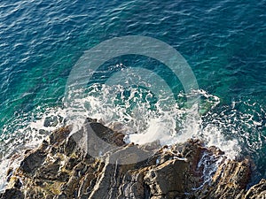 Sea water that breaks powerfully on the rocks photo