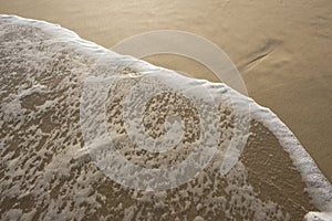 Sea Water and Foam on Beach