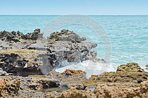 Sea water hitting the rocks on the bay photo