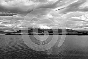 Sea water at mountain coast under cloudy sky in Rejkjavik, Iceland. Sea on mountain landscape. Beauty of wild nature