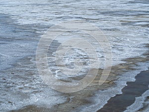 Sea water prepared in the salt field to let it dry from sun and become white sea salt in the field of Samut Songkram, Thailand, Fl