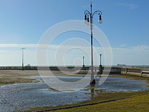 Sea water puddle surrounding a lamppost near the Terrazza Mascagni
