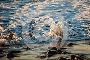 Sea water rushing over the shoreline rocks