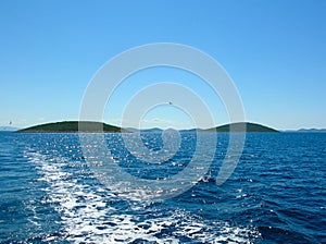 Sea water ship trail with white foamy wave. Tropical islands ferry travel. Bubble tail after cruise ship. Deep ocean view.