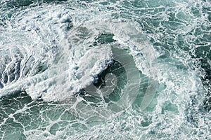 Sea water splash with foamy wave. Water surface texture