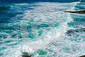 Sea water splash with foamy wave. Water surface texture.