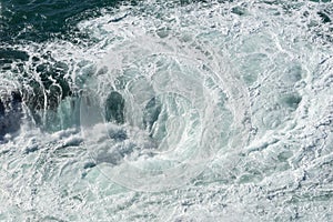 Sea water splash with foamy wave. Water surface texture