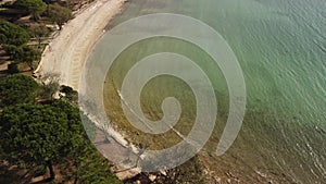 Sea water at springtime. Aerial top view of sandy beach and calm bay in spring